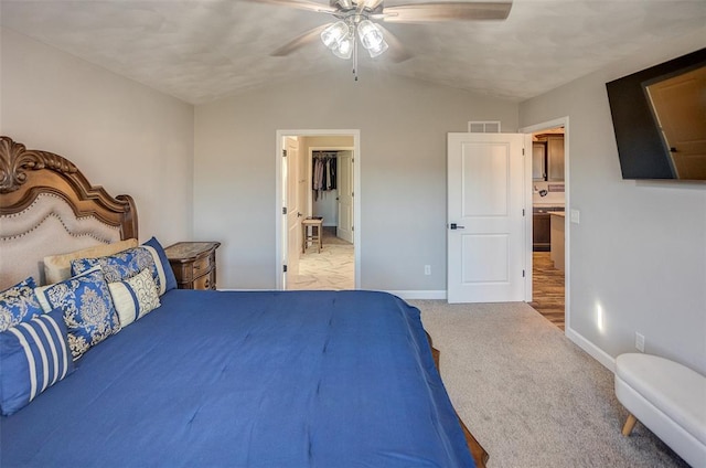 carpeted bedroom featuring lofted ceiling, baseboards, and ceiling fan