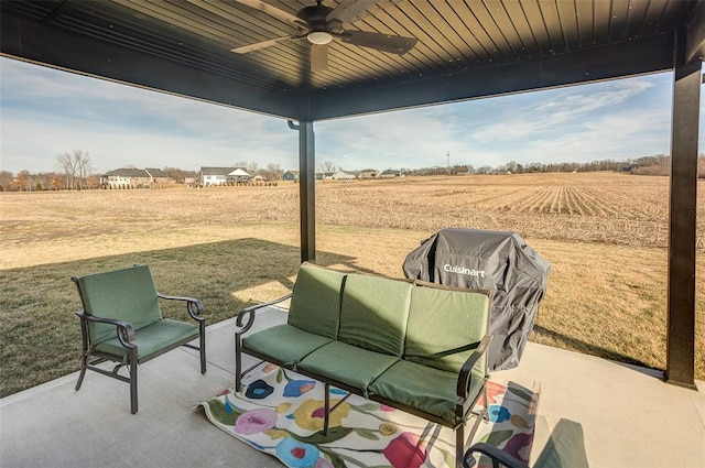 view of patio featuring ceiling fan and a view of countryside