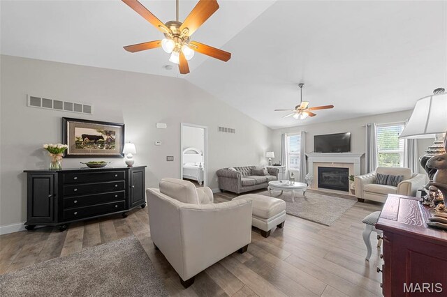 205 Stephanie Lynn Ct, Wentzville, MO 63385 - living area with a ceiling fan, vaulted ceiling, wood finished floors, a glass covered fireplace, and baseboards