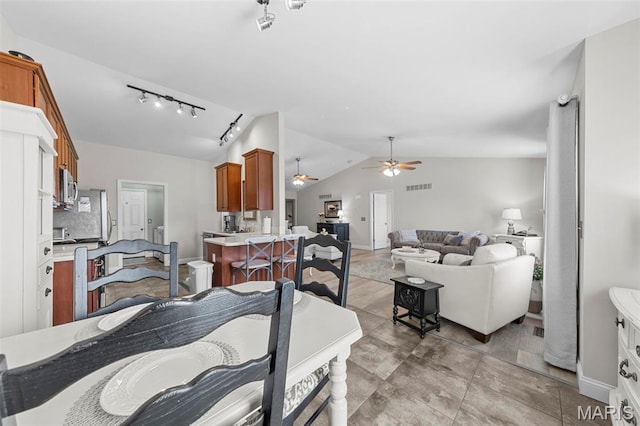 205 Stephanie Lynn Ct, Wentzville, MO 63385 - dining space featuring lofted ceiling, a ceiling fan, rail lighting, and baseboards