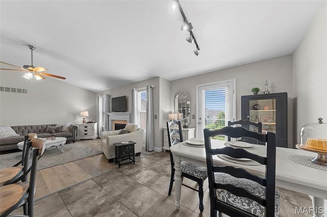 205 Stephanie Lynn Ct, Wentzville, MO 63385 - dining area with ceiling fan, a fireplace, and rail lighting