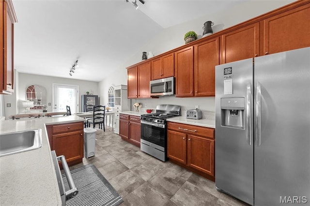 205 Stephanie Lynn Ct, Wentzville, MO 63385 - kitchen with appliances with stainless steel finishes, track lighting, vaulted ceiling, light countertops, and a sink