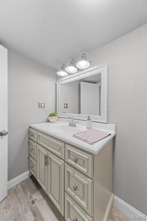 205 Stephanie Lynn Ct, Wentzville, MO 63385 - bathroom featuring baseboards, vanity, and wood finished floors