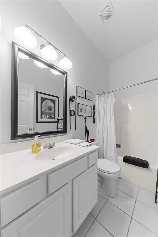 1008 Shire Ln, Eureka, MO 63025 - bathroom with tile patterned floors, toilet, vanity, and shower / tub combo