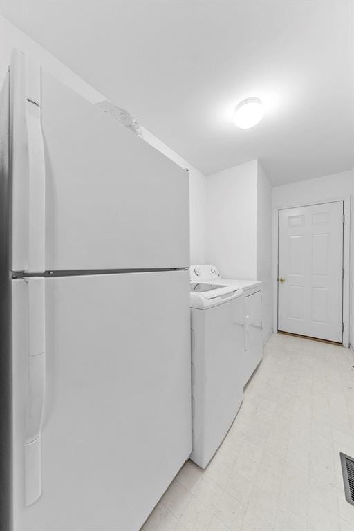 1008 Shire Ln, Eureka, MO 63025 - clothes washing area featuring light flooring and washing machine and dryer