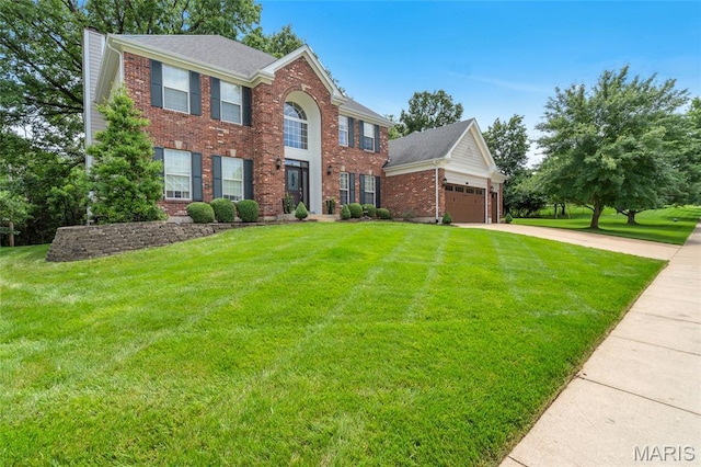 556 Autumn Bluff Dr, Ellisville, MO 63021 - colonial inspired home featuring brick siding, concrete driveway, a front yard, and a chimney