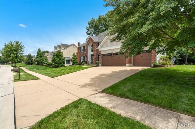 556 Autumn Bluff Dr, Ellisville, MO 63021 - view of front of house featuring brick siding, a front yard, concrete driveway, and a residential view