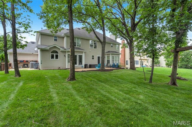 556 Autumn Bluff Dr, Ellisville, MO 63021 - back of house featuring a patio area and a yard