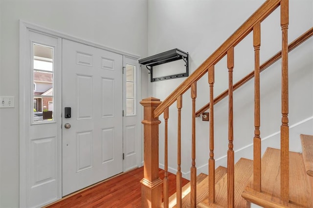 entrance foyer with wood finished floors and stairway