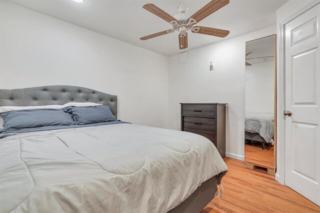 bedroom with light wood finished floors, ceiling fan, and baseboards
