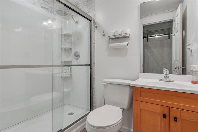 full bathroom featuring a shower stall, toilet, and vanity