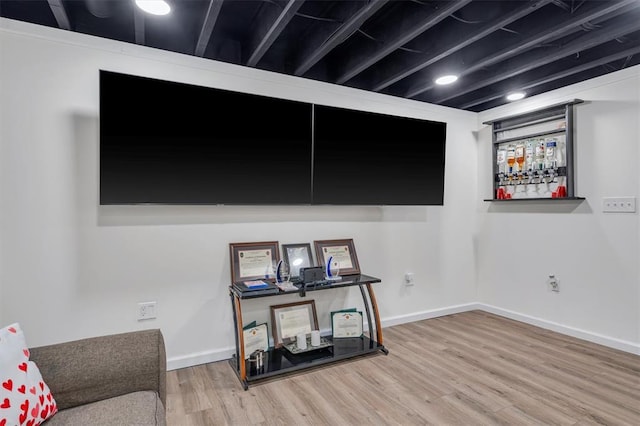 living area featuring wood finished floors and baseboards
