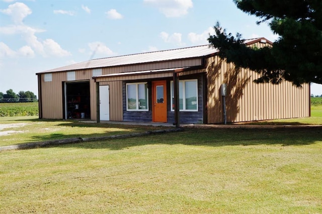 7526 State Highway 164, Cardwell, MO 63829 - back of house featuring a lawn and a garage
