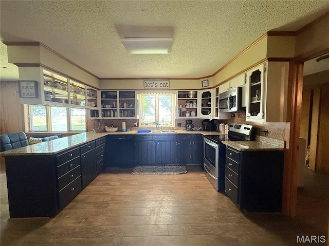7526 State Highway 164, Cardwell, MO 63829 - kitchen with stainless steel appliances, open shelves, ornamental molding, hardwood / wood-style floors, and a textured ceiling