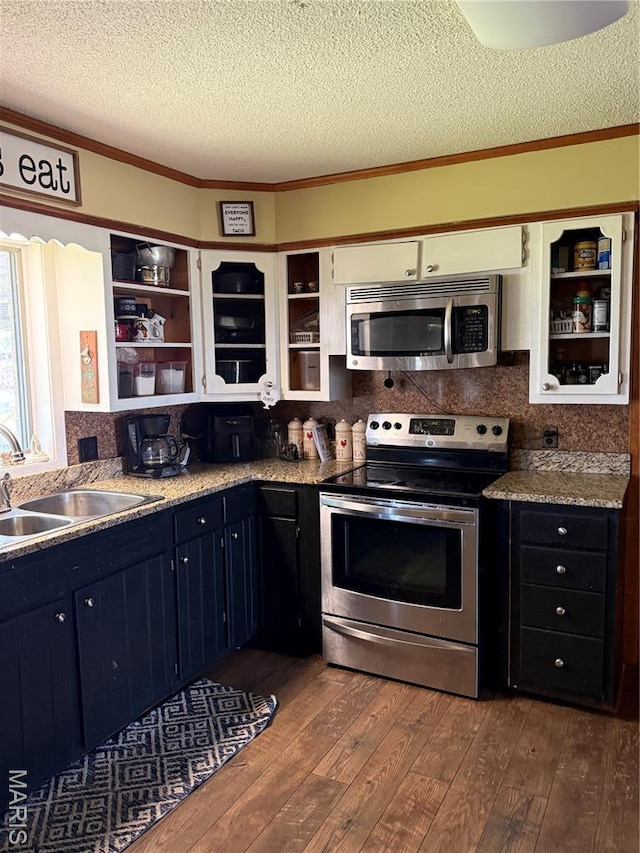 7526 State Highway 164, Cardwell, MO 63829 - kitchen with stainless steel appliances, open shelves, dark wood-style flooring, a textured ceiling, and backsplash