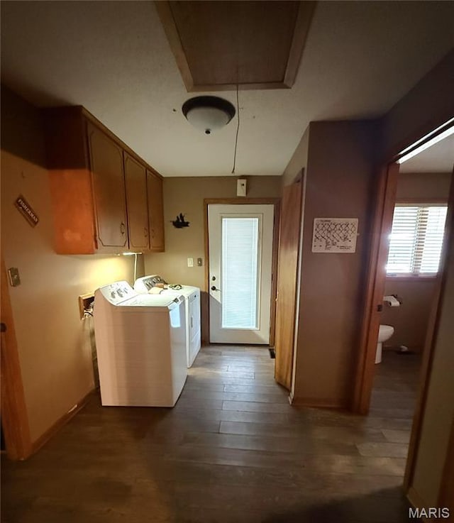 7526 State Highway 164, Cardwell, MO 63829 - laundry room featuring attic access, washing machine and clothes dryer, dark wood-style flooring, and cabinet space