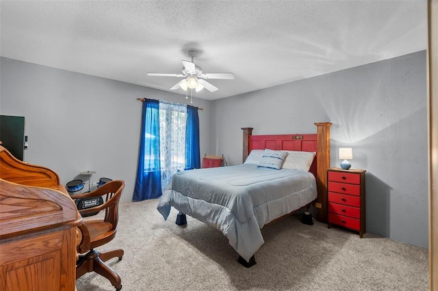 carpeted bedroom with a textured ceiling and a ceiling fan