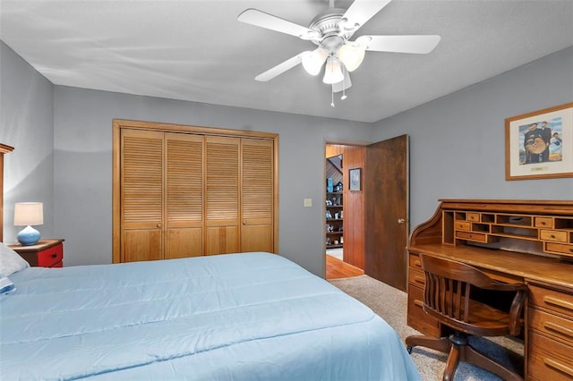 carpeted bedroom featuring a closet and a ceiling fan