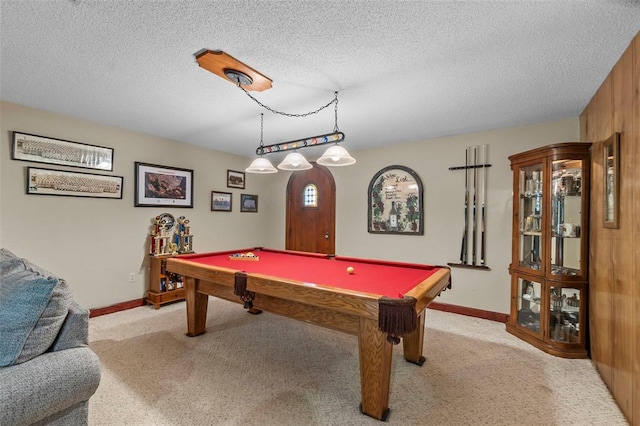 playroom featuring light colored carpet, billiards table, baseboards, and a textured ceiling