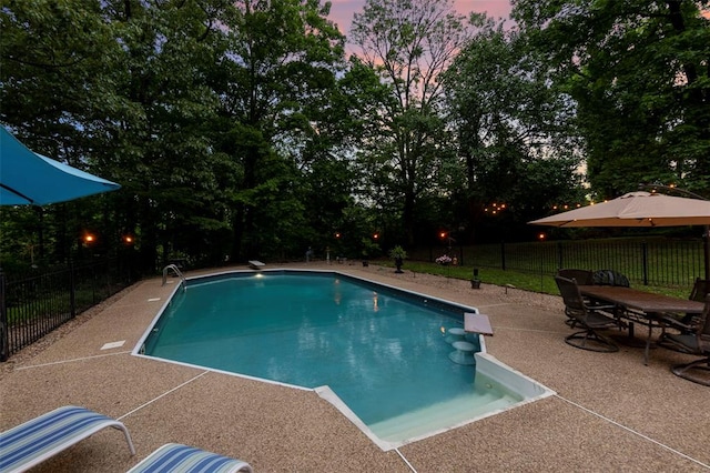 view of swimming pool featuring a patio area and fence