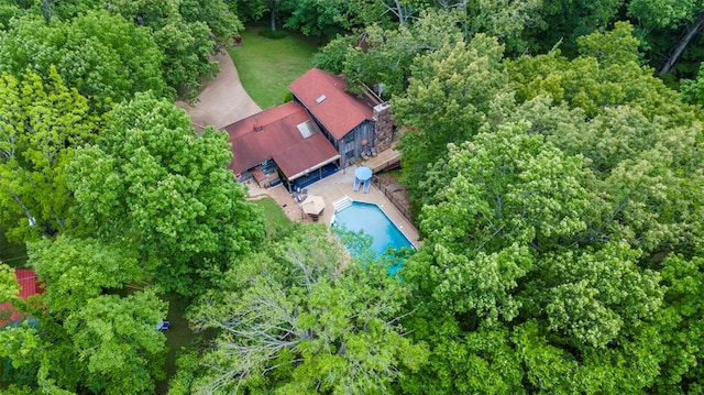 view of subject property with a pool