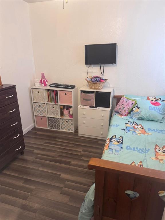313 W Crumb Ave, Bernie, MO 63822 - bedroom with dark wood-type flooring and baseboards