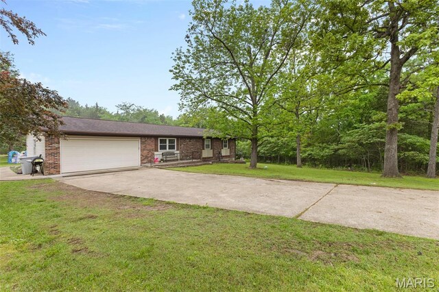 1414 Rue Camille, Bonne Terre, MO 63628 - view of front facade with driveway, an attached garage, brick siding, and a front lawn