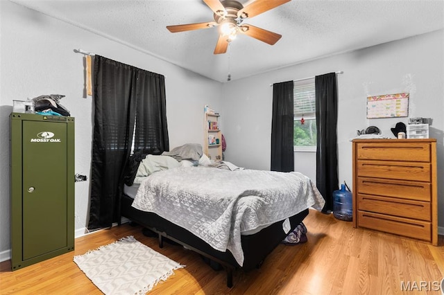 1414 Rue Camille, Bonne Terre, MO 63628 - bedroom featuring light wood-style flooring, a ceiling fan, and a textured ceiling