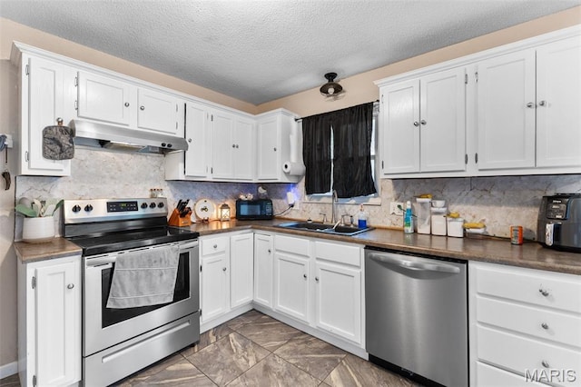 1414 Rue Camille, Bonne Terre, MO 63628 - kitchen featuring stainless steel appliances, under cabinet range hood, white cabinetry, a textured ceiling, and dark countertops