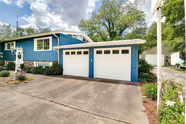 23571 Peppermill Ln, Hettick, IL 62649 - view of front of home with an attached garage, concrete driveway, and metal roof