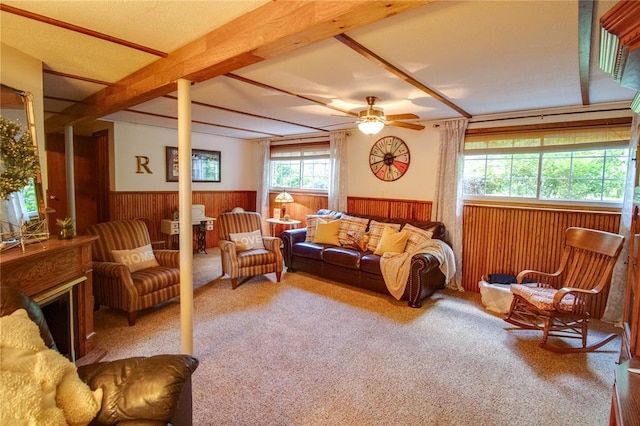 23571 Peppermill Ln, Hettick, IL 62649 - living area featuring wainscoting, a ceiling fan, wood walls, carpet flooring, and a fireplace