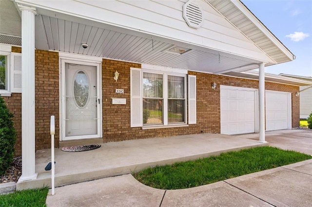 226 Ridgeview Dr, Columbia, IL 62236 - doorway to property featuring brick siding, driveway, a garage, and a security system