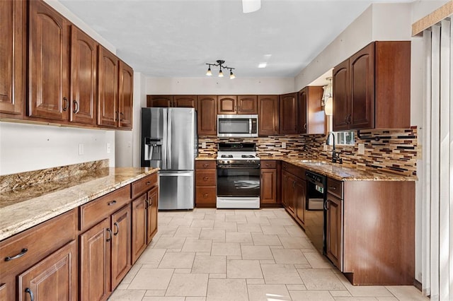 226 Ridgeview Dr, Columbia, IL 62236 - kitchen featuring appliances with stainless steel finishes, a sink, light stone countertops, and tasteful backsplash