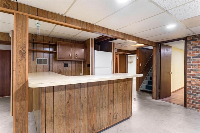 226 Ridgeview Dr, Columbia, IL 62236 - kitchen with freestanding refrigerator, open shelves, a paneled ceiling, a peninsula, and concrete flooring