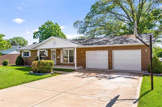 226 Ridgeview Dr, Columbia, IL 62236 - view of front of house with a garage, concrete driveway, a front lawn, a porch, and brick siding