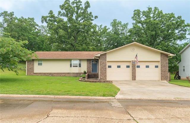 2137 Inman Rd, Poplar Bluff, MO 63901 - ranch-style house featuring brick siding, a garage, a front lawn, and concrete driveway