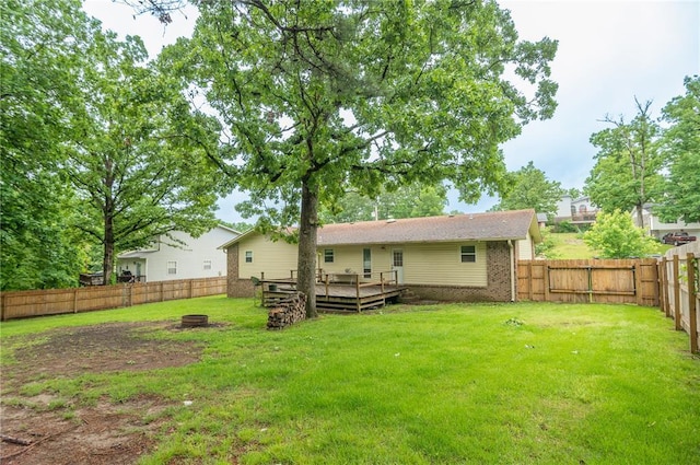 2137 Inman Rd, Poplar Bluff, MO 63901 - back of property with a wooden deck, a fire pit, and brick siding
