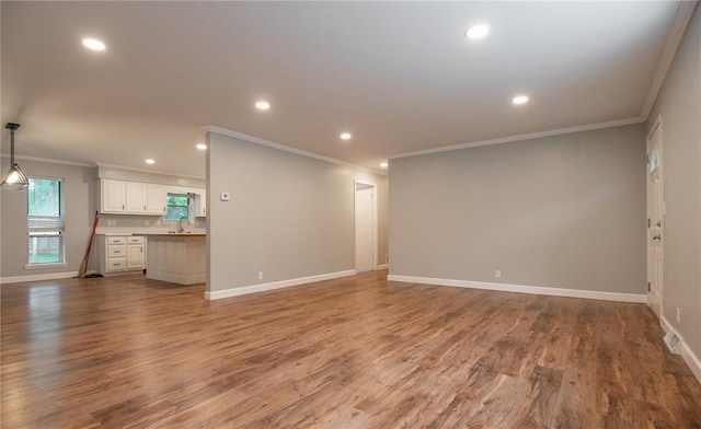 2137 Inman Rd, Poplar Bluff, MO 63901 - unfurnished living room featuring ornamental molding, wood finished floors, recessed lighting, baseboards, and a sink
