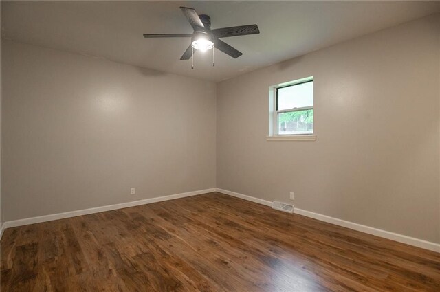 2137 Inman Rd, Poplar Bluff, MO 63901 - unfurnished room featuring baseboards, dark wood finished floors, and a ceiling fan