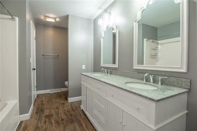 2137 Inman Rd, Poplar Bluff, MO 63901 - full bath featuring wood finished floors, toilet, baseboards, a shower, and double vanity