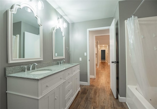 2137 Inman Rd, Poplar Bluff, MO 63901 - bathroom featuring wood finished floors, baseboards, and double vanity