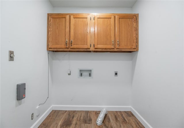 2137 Inman Rd, Poplar Bluff, MO 63901 - washroom featuring hookup for an electric dryer, cabinet space, hookup for a washing machine, baseboards, and dark wood-style flooring
