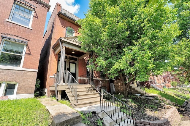 4541 Oakland Ave, Saint Louis, MO 63115 - view of front of house featuring stairs, brick siding, and covered porch