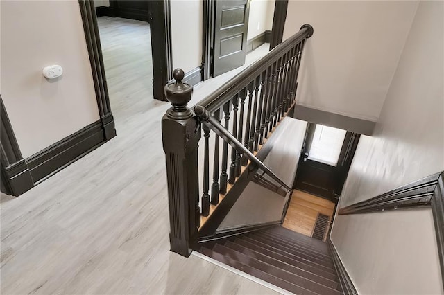 4541 Oakland Ave, Saint Louis, MO 63115 - staircase featuring wood finished floors and baseboards