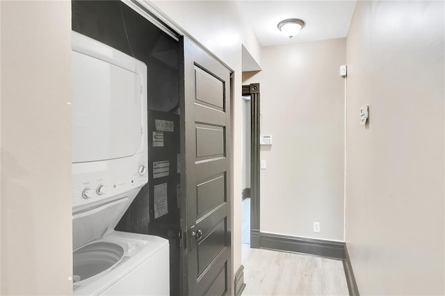 4541 Oakland Ave, Saint Louis, MO 63115 - laundry room with stacked washer / drying machine, wood finished floors, and baseboards