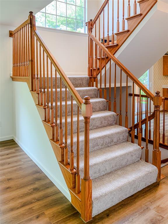 stairway featuring baseboards and wood finished floors