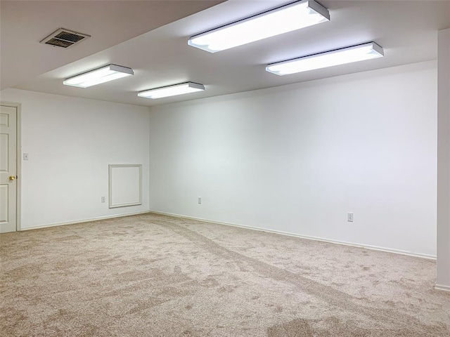 carpeted empty room featuring baseboards