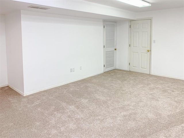 unfurnished room with carpet flooring and baseboards