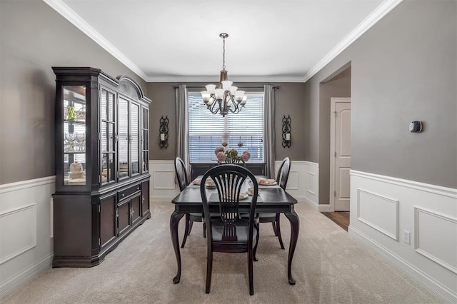 40 Burnside Ct, Frontier Township, MO 63303 - dining room with a chandelier, a wainscoted wall, ornamental molding, and light colored carpet