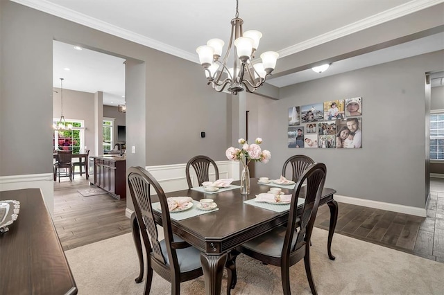 40 Burnside Ct, Frontier Township, MO 63303 - dining room with a chandelier, wood finished floors, plenty of natural light, crown molding, and baseboards